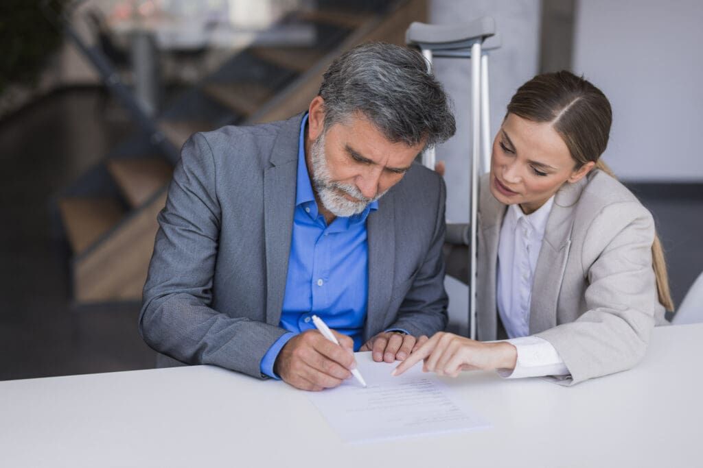 Man filling out workers comp claim paperwork in a law office